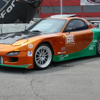 Orange 1994 Mazda RX-7 on Silver/Chrome Enkei RPF1 type RC