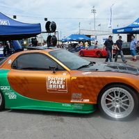 Orange 1994 Mazda RX-7 on Silver/Chrome Enkei RPF1 type RC