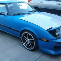 Blue 1985 Mazda RX-7 on Silver/Chrome OZ Racing Crono HT