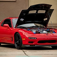 Red 1993 Mazda RX-7 on Black Enkei PF01